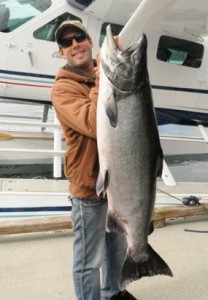 Holding fish in fron of airoplane